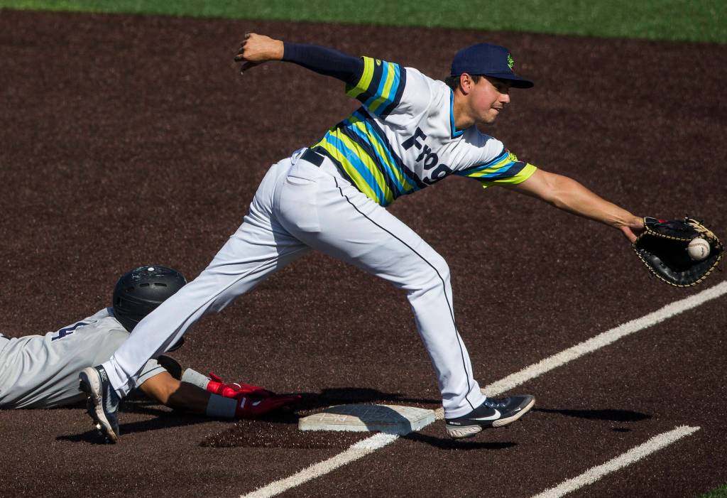 AquaSoxs Austin Shenton reaches for an other thrown ball to first base during the game against the Dust Devils on Sunday, May 16, 2021 in Everett, Wash.