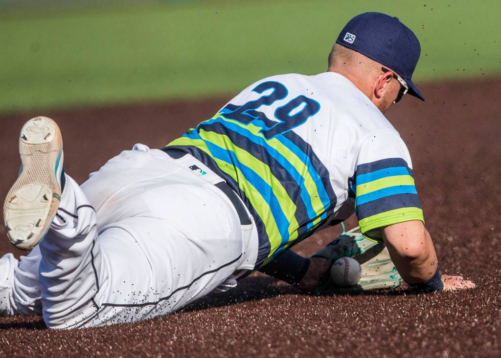 AquaSoxs Tyler Keenan dives for the ball during the game against the Dust Devils on Sunday, May 16, 2021 in Everett, Wash.