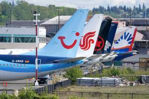 Boeing 737 Max airplanes, including one belonging to TUI Group, left, sit parked at a storage lot, Monday, April 26, 2021, near Boeing Field in Seattle.  Lawmakers, on Tuesday, May 18,  are asking Boeing and the Federal Aviation Administration for records detailing production problems with two of the company's most popular airliners. The lawmakers are focusing on the Boeing 737 Max and a larger plane, the 787, which Boeing calls the Dreamliner.  (AP Photo/Ted S. Warren)