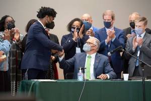Washington Gov. Jay Inslee thanks state Rep. Jesse Johnson after signing legislation Johnson sponsored - one of 12 bills about police accountability and reform signed by the governor - during a ceremony at the Eastside Community Center in Tacoma, Wash., on Tuesday, May 18, 2021. (Tony Overman/The News Tribune via AP)