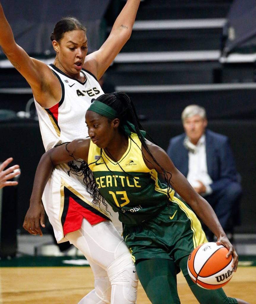 Seattles Ezi Magbegor controls the ball with Las Vegas Liz Cambage defending Tuesday night at the Angel of the Winds Arena in Everett on May 18, 2021. (Kevin Clark / The Herald)