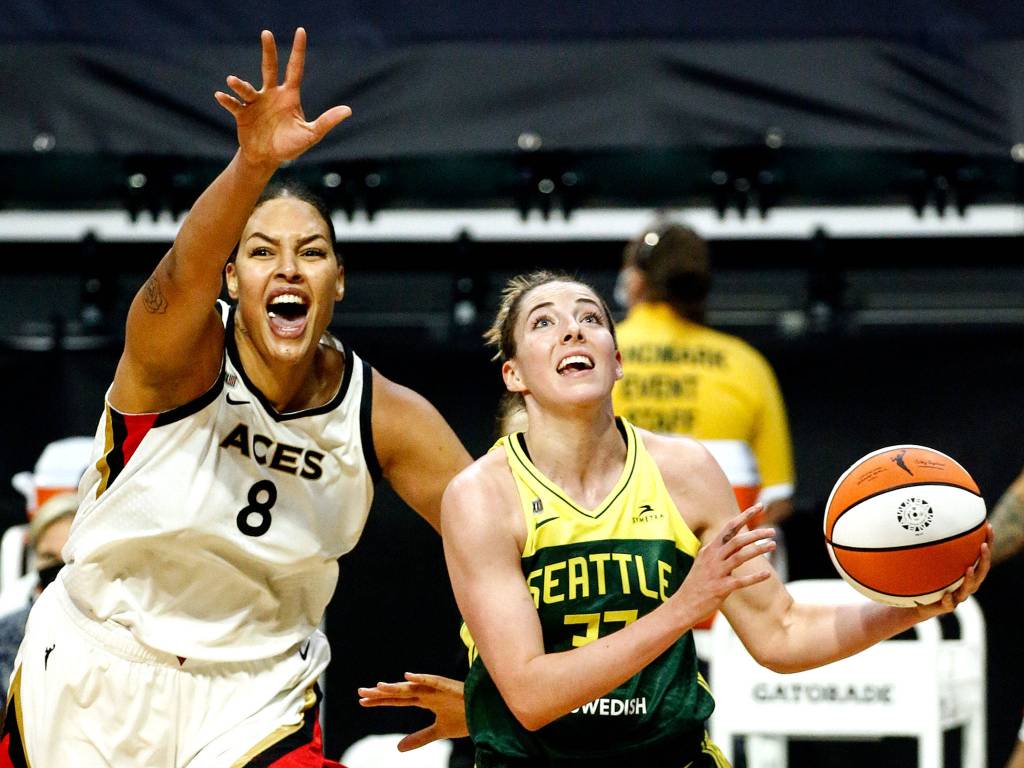 Seattles Katie Lou Samuelson drives the baseline with Las Vegas Liz Cambage trailing Tuesday night at the Angel of the Winds Arena in Everett on May 18, 2021. (Kevin Clark / The Herald)