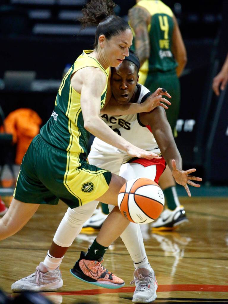 Las Vegas Chelsea Gray knocks free the ball from Seattles Sue Bird Tuesday night at the Angel of the Winds Arena in Everett on May 18, 2021. (Kevin Clark / The Herald)
