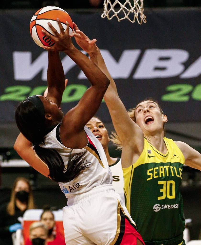 Las Vegas Jackie Young attempts a shot against Seattles Breanna Stewart Tuesday night at the Angel of the Winds Arena in Everett on May 18, 2021. (Kevin Clark / The Herald)