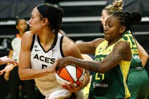 Seattle's Jewell Loyd (right) wrestles the ball from Las Vegas' Dearica Hamby Tuesday night at the Angel of the Winds Arena in Everett on May 18, 2021.  (Kevin Clark / The Herald)