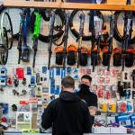 Jay Hiester, owner of Tims Bike Shop, helps a customer pick out a rear tire Friday in Everett. (Olivia Vanni / The Herald)