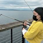 Allison Kim, 10, awaits a bite as she fishes at the new fishing pier Sunday near the Mukilteo ferry terminal. (Julie Muhlstein / The Herald)
