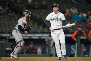 Seattle Mariners' Kyle Seager, right, reacts after striking out swinging with two men on base as Detroit Tigers catcher Eric Haase, left holds the ball during the eighth inning of a baseball game Wednesday, May 19, 2021, in Seattle. (AP Photo/Ted S. Warren)