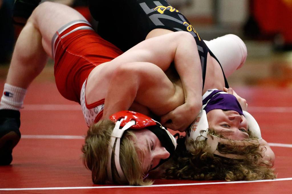 Stanwoods Tyler Rhue (left) wrestles Lake Stevens Aiden Eberlein during a match on May 20, 2021, at Stanwood High School. Lake Stevens won 48-33. (Kevin Clark / The Herald)