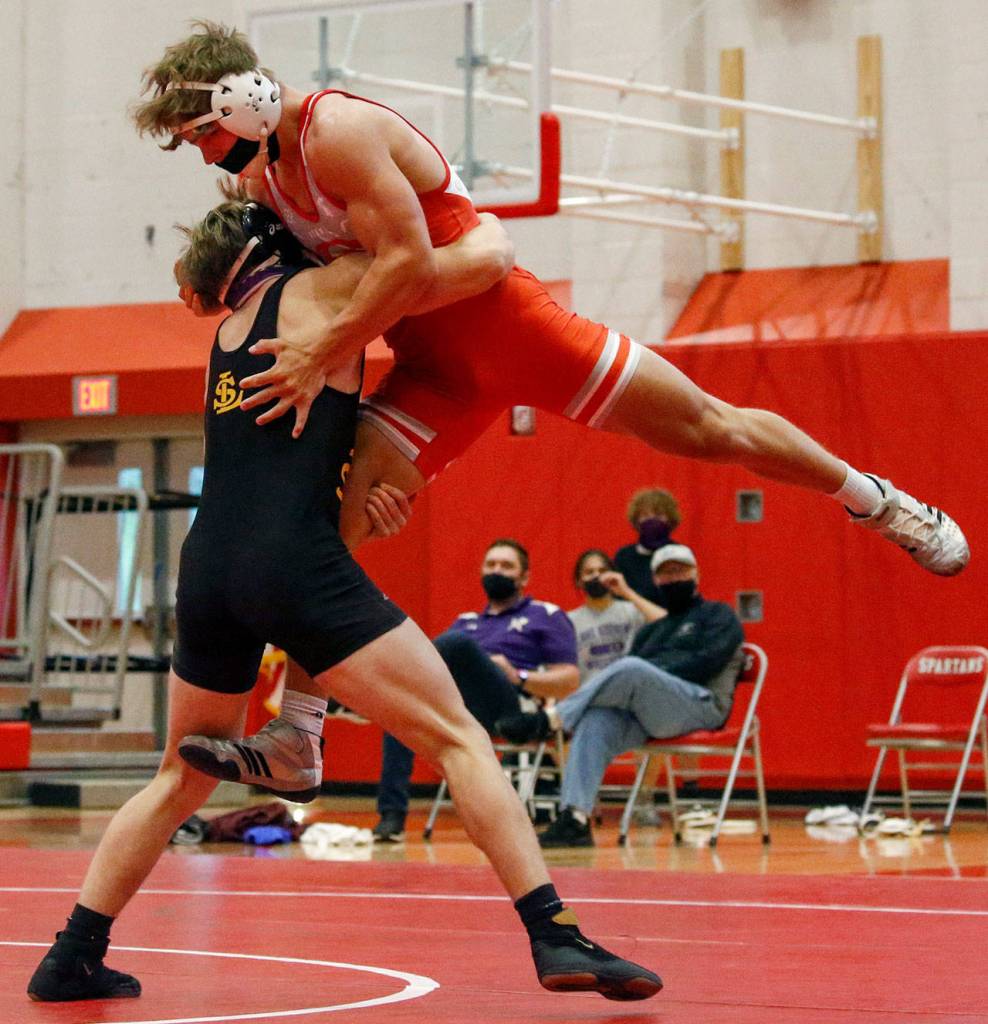 Lake Stevens Wyatt Springer (left) wrestles Stanwoods Ryder Bumgarner during a match on May 20, 2021, at Stanwood High School. Lake Stevens won 48-33. (Kevin Clark / The Herald)