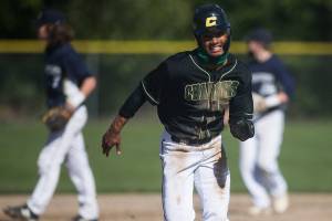 Marysville Getchell's Malakhi Knight runs to third base for a steal during the game against Arlington on Friday, May 7, 2021 in Arlington, Wash. (Olivia Vanni / The Herald)