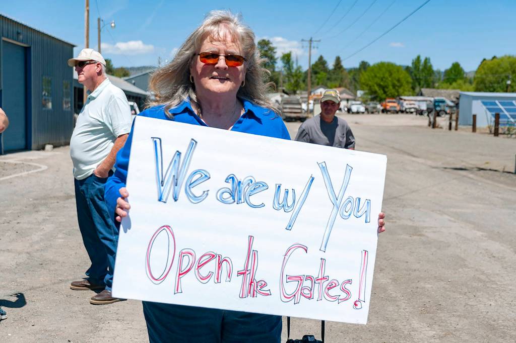 About 30 people affiliated with Peoples Rights Oregon gathered at Klamath Irrigation District headquarters in Klamath Falls, Oregon, on May 13, to protest after federal regulators shut off irrigation water to farmers from a critical reservoir due to drought conditions. (Alex Schwartz/The Herald And News via AP)