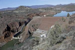 FILE - In this March 3, 2020, file photo, is the Iron Gate Dam, powerhouse and spillway are on the lower Klamath River near Hornbrook, Calif. The U.S. Bureau of Reclamation said this week that it won't release water into the main canal that feeds the massive Klamath Project irrigation system, marking the first time in 114 years that no water has flowed in the so-called A Canal. The agency announced last month that irrigators would get dramatically less water than usual, but a worsening drought picture means water will be completely shut off instead, the agency said. (AP Photo/Gillian Flaccus, File)