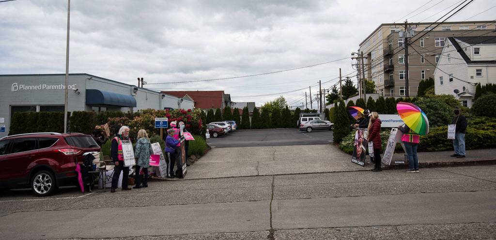 Anti-abortion and pro-choice advocates face each other Wednesday in front of the Planned Parenthood building on 32nd Street in Everett. (Andy Bronson / The Herald)