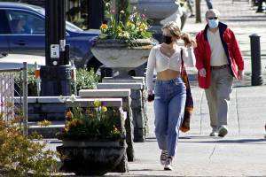 FILE - In this April 11, 2021, file photo, residents wearing masks walk in downtown Lake Oswego, Ore. Even as the federal Centers for Disease Control and Prevention moved earlier this month to ease indoor face mask-wearing guidance for fully vaccinated people, states like Oregon and Washington are still holding on to certain longtime coronavirus restrictions (AP Photo/Gillian Flaccus, File)