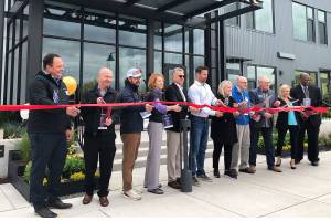 Officials from SeaLevel Properties, Gracorp, the Port of Everett and the Snohomish County Council gather Wednesday to celebrate the opening of the new Waterfront Place Apartments at Waterfront Place Central near West Marine View Drive between 10th and 13th streets. The north building, with 135 apartments, opened to tenants earlier this month. The south building, with 131 units, is expected to open next year. May 26, 2021 (Janice Podsada / The Herald)