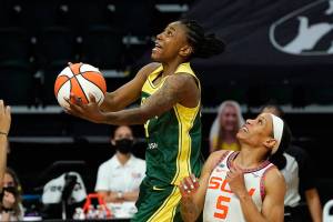 Seattle Storm's Jewell Loyd shoots next to Connecticut Sun's Jasmine Thomas in overtime of a WNBA basketball game Tuesday, May 25, 2021, in Everett, Wash. The Storm won 90-87. (AP Photo/Elaine Thompson)