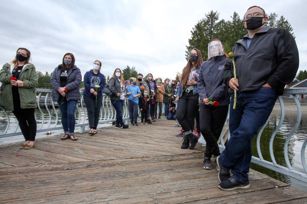 People gather on the one-year anniversary of the death of George Floyd at Lundeen Park in Lake Stevens on Tuesday. (Kevin Clark / The Herald)