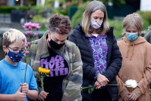 A moment of silence is observed by those gathered in Lundeen Park in Lake Stevens to mark the one-year anniversary of the death of George Floyd. Taken May 25, 2021. (Kevin Clark / The Herald)