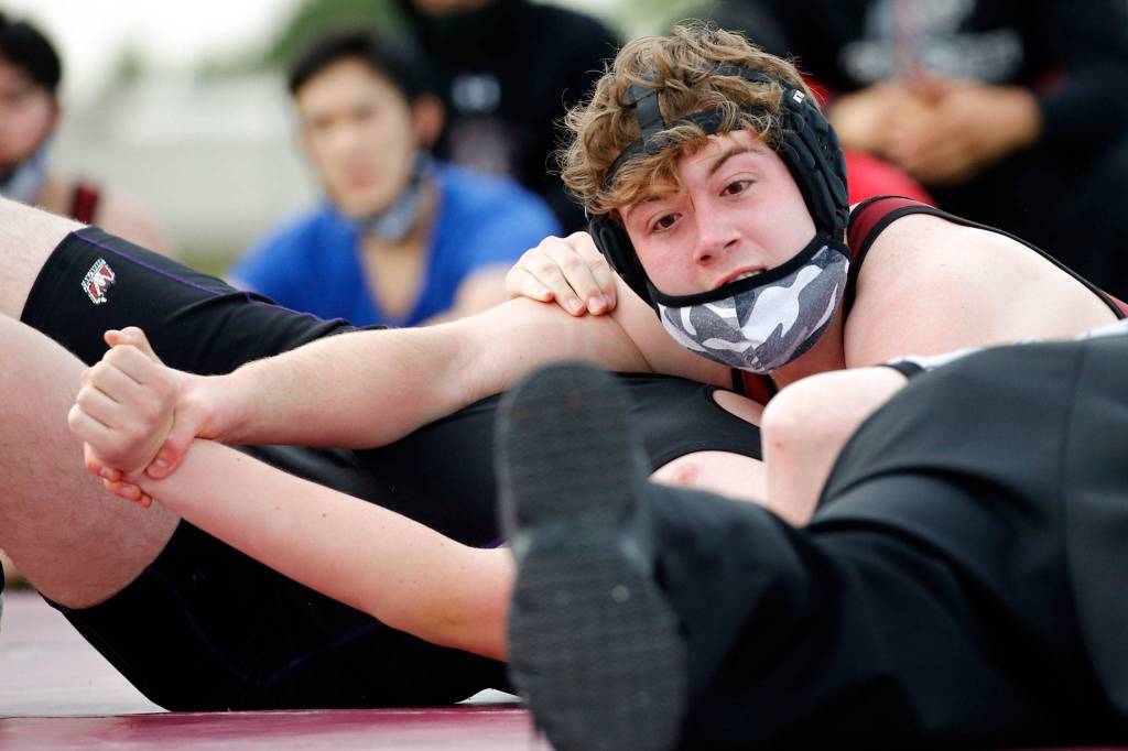Cascades Ronan McKague works to pin Kamiaks Riley Frasier during an outdoor dual meet on Wednesday afternoon at Cascade High School in Everett. Kamiak won 43-42 on forfeit criteria. (Kevin Clark / The Herald)