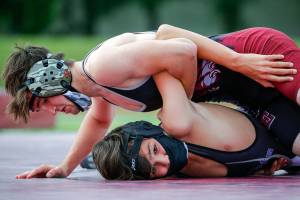 Cascade's Jeremy Delap (top) wrestles Kamiak's Braden Watkins Wednesday afternoon at Cascade High School in Everett on May 26, 2021. Kamiak won, 42-42, on a tie-breaker technicality (Kevin Clark / The Herald)