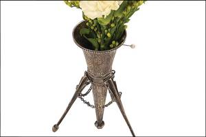 A tussie mussie is a flower holder popular in the late 19th century. It was filled with fresh flowers to be sniffed during an evening to cover the unpleasant smells of poor sanitation. (Cowles Syndicate Inc.)