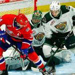 Chiefs' Adam Beckman (left) and Silvertips' Zach Ashton struggle for the puck in front of Silvertips' Dustin Wolf during the final home game Friday night at Angel of the Winds Arena in Everett on May 7, 2021.  (Kevin Clark / The Herald)