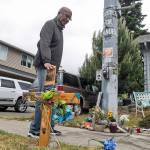 Billy Williams stops by a memorial Thursday in Tacoma, where Manuel Ellis died while in police custody. The Washington state attorney general on Thursday charged two Tacoma police officers with murder and one with manslaughter in the death of Ellis, a Black man who died after telling them he couldnt breathe as he was being restrained. (Tony Overman/The News Tribune via AP)