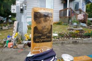 A sign that reads Gone but not forgotten is shown on a cross displayed May 27 at a memorial that has been established at the intersection in Tacoma, where Manuel Manny Ellis died on March 3, 2020, after he was restrained by police officers. (AP Photo/Ted S. Warren)