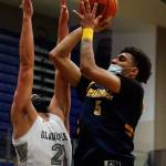 Mariners Henry Avra (right) attempts a shot with Glacier Peaks Torey Watkins defending during a game Thursday evening at Glacier Peak High School in Snohomish. Mariner won 64-36. (Kevin Clark / The Herald)