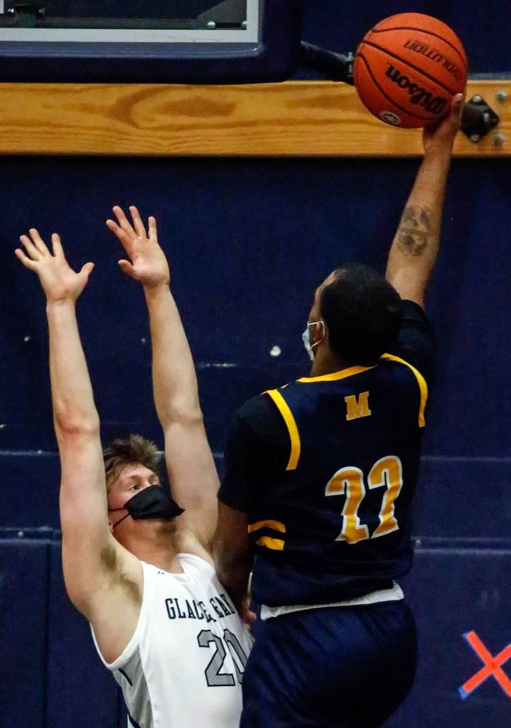 Mariners Naser Motley (right) attempts a shot with Glacier Peaks Tyson Willis defending during a game Thursday evening at Glacier Peak High School in Snohomish. Mariner won 64-36. (Kevin Clark / The Herald)