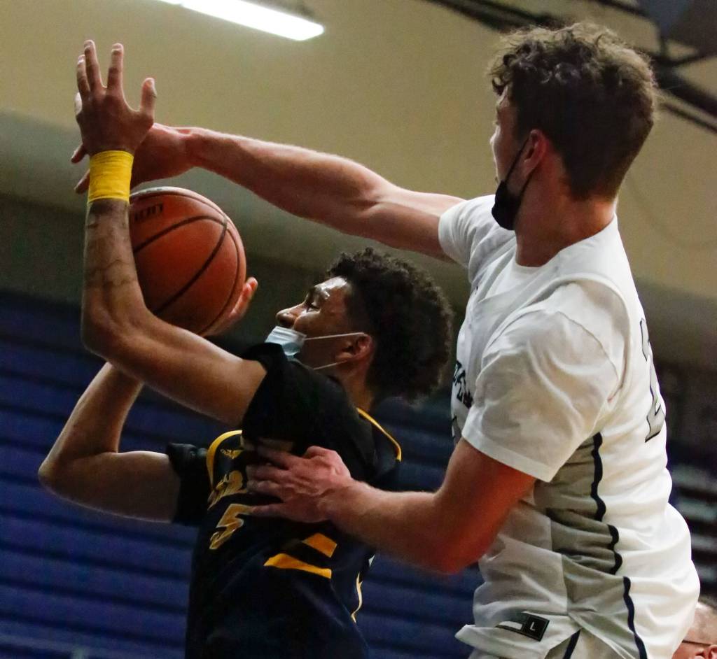 Mariners Henry Avra drives the lane with Glacier Peaks Cooper Jensen defending during a game Thursday evening at Glacier Peak High School in Snohomish. Mariner won 64-36. (Kevin Clark / The Herald)