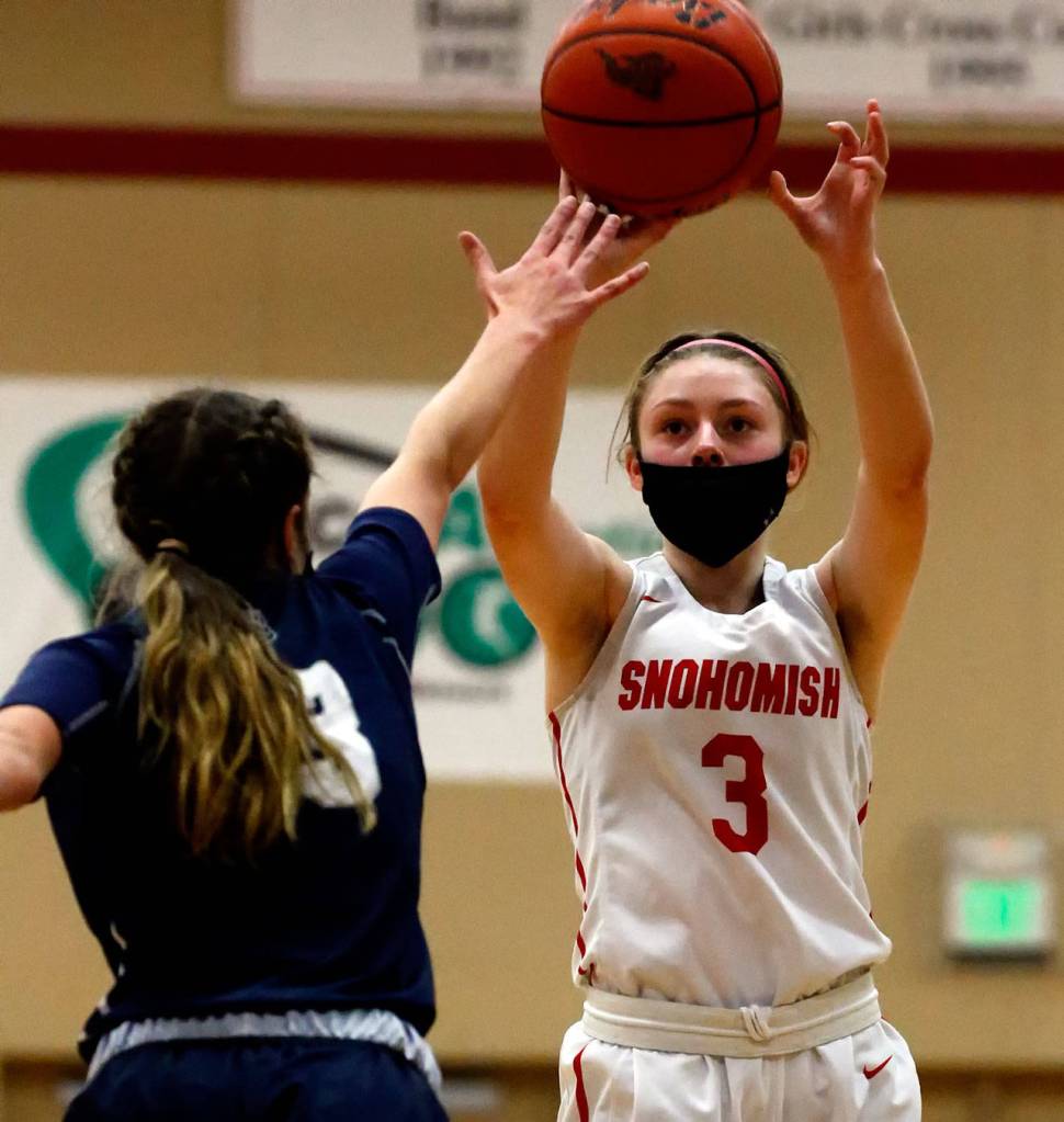 Snohomishs Cheyenne Rodgers attempts a shot with Glacier Peaks Hailey Stevenson defending during a game on Friday evening at Snohomish High School. Grizzlies won 59-35. (Kevin Clark / The Herald)
