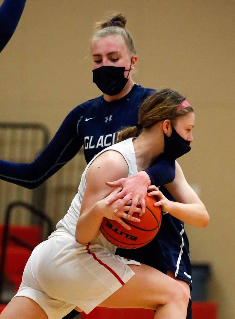 Snohomishs Cheyenne Rodgers works to get around Glacier Peaks Madison Rubino during a game on Friday evening at Snohomish High School. Grizzlies won 59-35. (Kevin Clark / The Herald)