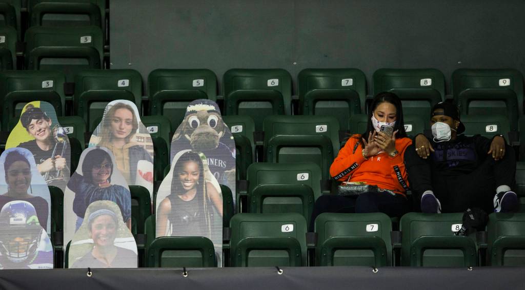 Fans sit social distanced next to cardboard cutouts during game between Seattle Storm and Minnesota Lynx on Friday, May 28, 2021 in Everett, Wash. (Olivia Vanni / The Herald)