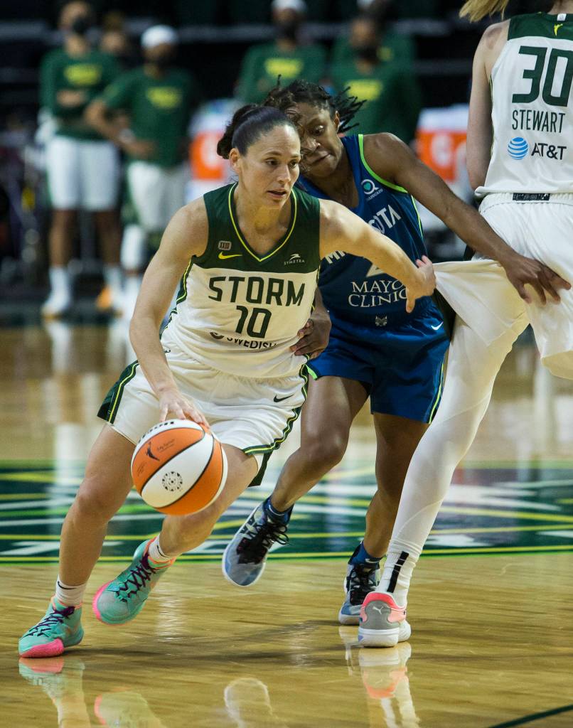Seattle Storms Sue Bird maneuvers around a screen by Breanna Stewart during the game against Minnesota on Friday, May 28, 2021 in Everett, Wash. (Olivia Vanni / The Herald)