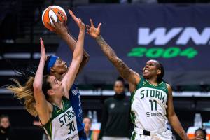 Minnesota Lynx center Sylvia Fowles center gets the rebound and the putback during the first quarter, besting Seattle Storm's Breanna Stewart, left, and Epiphanny Prince (11) of a WNBA basketball game Friday, May 28, 2021, in Everett, Wash. (Dean Rutz/The Seattle Times via AP)