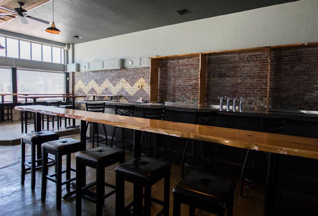 Wooden bar tops and custom bar shelves inside the new Flying Pig in Everett. (Olivia Vanni / The Herald)