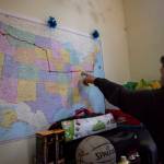 Deven Boyce, 14, points out designated stop locations along the route on a map at his Mukilteo home before leaving on the cross-country ride. (Olivia Vanni / The Herald)