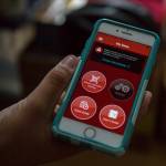 Deven Boyce shows an app that will connect to a bluetooth-equipped helmet that will allow him to talk to his grandfather and to connect online. (Olivia Vanni / The Herald)