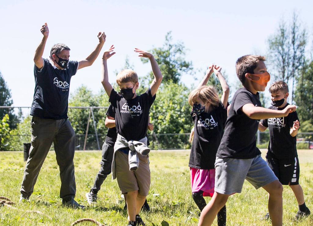Jeff Thoreson cheers with his students after his class wins a tug-of-war game at Riverview Elementary School on Thursday in Snohomish. (Olivia Vanni / The Herald)