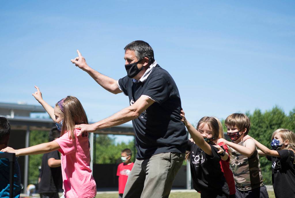 Jeff Thoreson has an outdoor dance party with his second-grade class on Thursday. (Olivia Vanni / The Herald)
