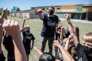 Jeff Thoreson does a cheer with his second grade class before the start of their kickball game on his last in-person day of school on Thursday, June 17, 2021 in Snohomish, Wa. (Olivia Vanni / The Herald)