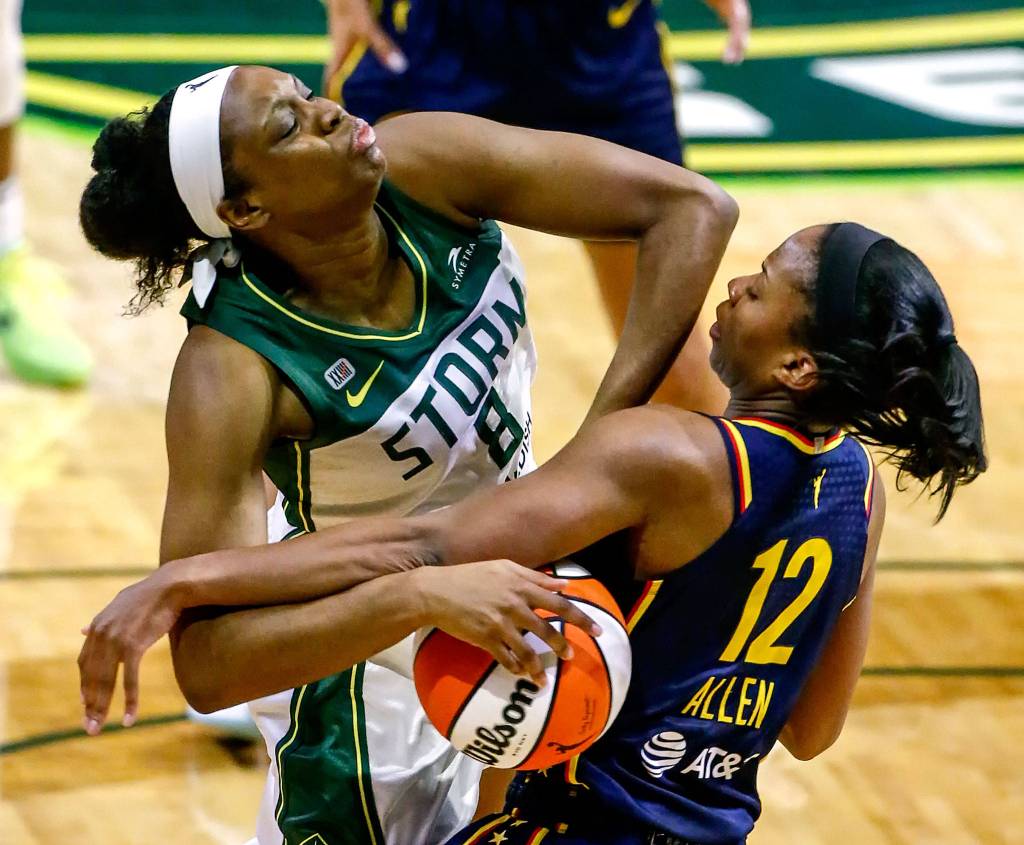 The Storms Kennedy Burke (left) is fouled by Indianas Lindsay Allen on Tuesday evening at Angel of the Winds Arena in Everett. (Kevin Clark / The Herald)