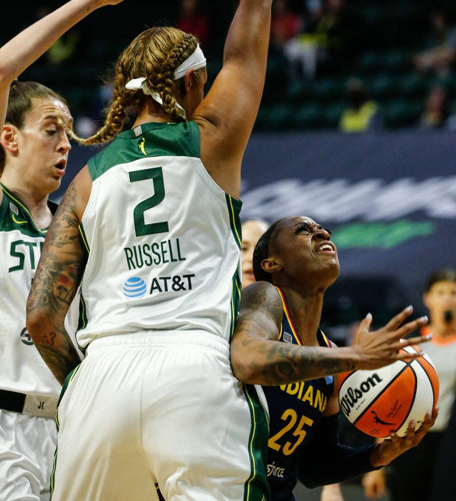 Indianas Tiffany Mitchell looks to the basket with the Storms Breanna Stewart (left) and Mercedes Russell defending Tuesday evening at Angel of the Winds Arena in Everett. (Kevin Clark / The Herald)