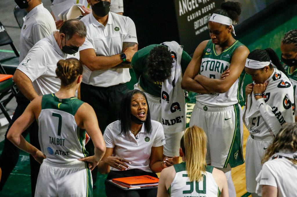 Storm coach Noelle Quinn (center) runs a timeout huddle Tuesday evening at Angel of the Winds Arena in Everett. (Kevin Clark / The Herald)