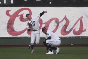 Aquasox's Jack Larsen throws the ball over teammate Julio Rodriguez.  The Everett Aquasox beat the Tri-City Dust Devils in a home opening game at Funko Field on Tuesday, May 11, 2021 in Everett, Washington.  (Andy Bronson / The Herald)