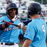 The AquaSox Miguel Perez (left) is welcomed home by teammate Zach DeLoach after hitting a home run in the bottom of the third inning during a game against the Hops on Thursday evening at Funko Field in Everett. (Kevin Clark / The Herald)