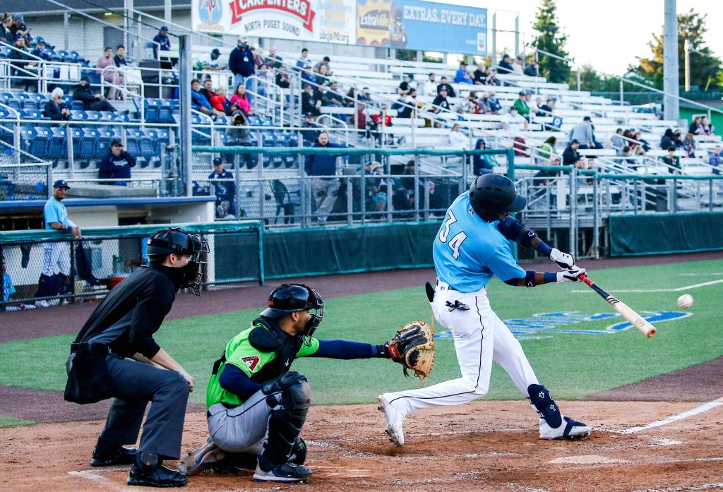 The AquaSoxs Miguel Perez hits a home run during a game against the Hops on Thursday evening at Funko Field in Everett. (Kevin Clark / The Herald)
