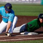 The AquaSoxs Connor Hoover attempts a tag on the Hops Cam Coursey during a game on Thursday evening at Funko Field in Everett. (Kevin Clark / The Herald)